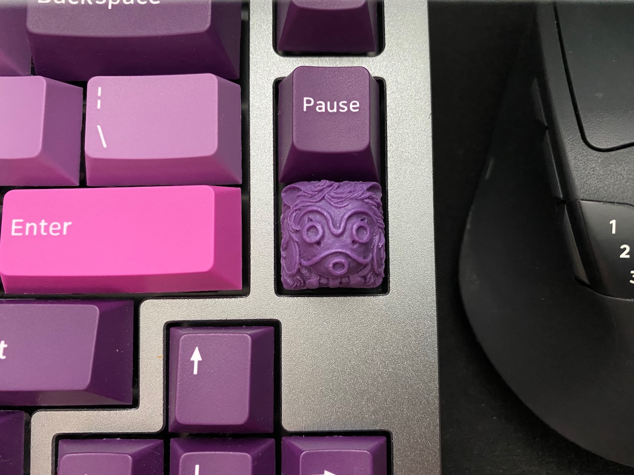 A purple artisan keycap.