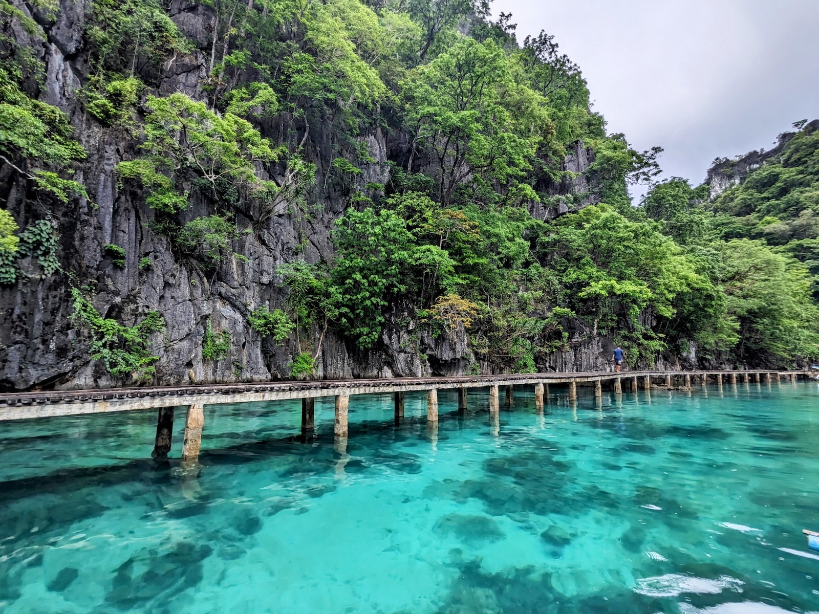 Wooden walkway over clear turquoise water