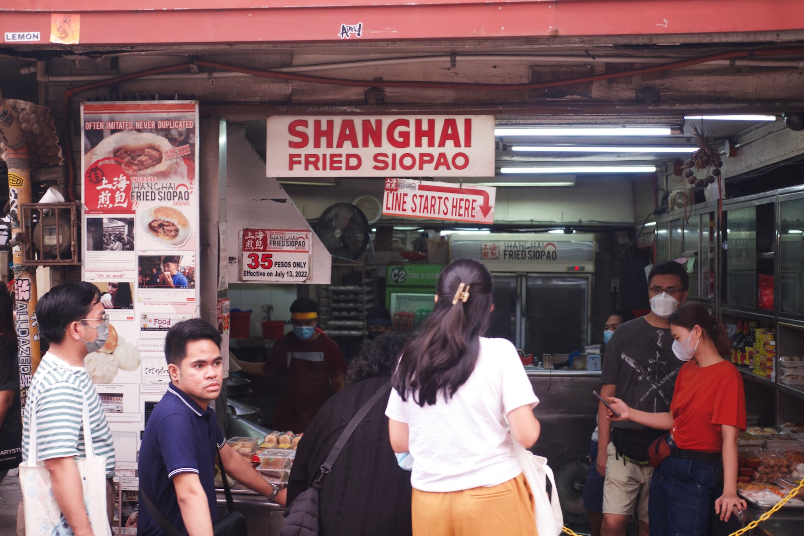 A small lunch stand advertises Shanghai fried siopao.