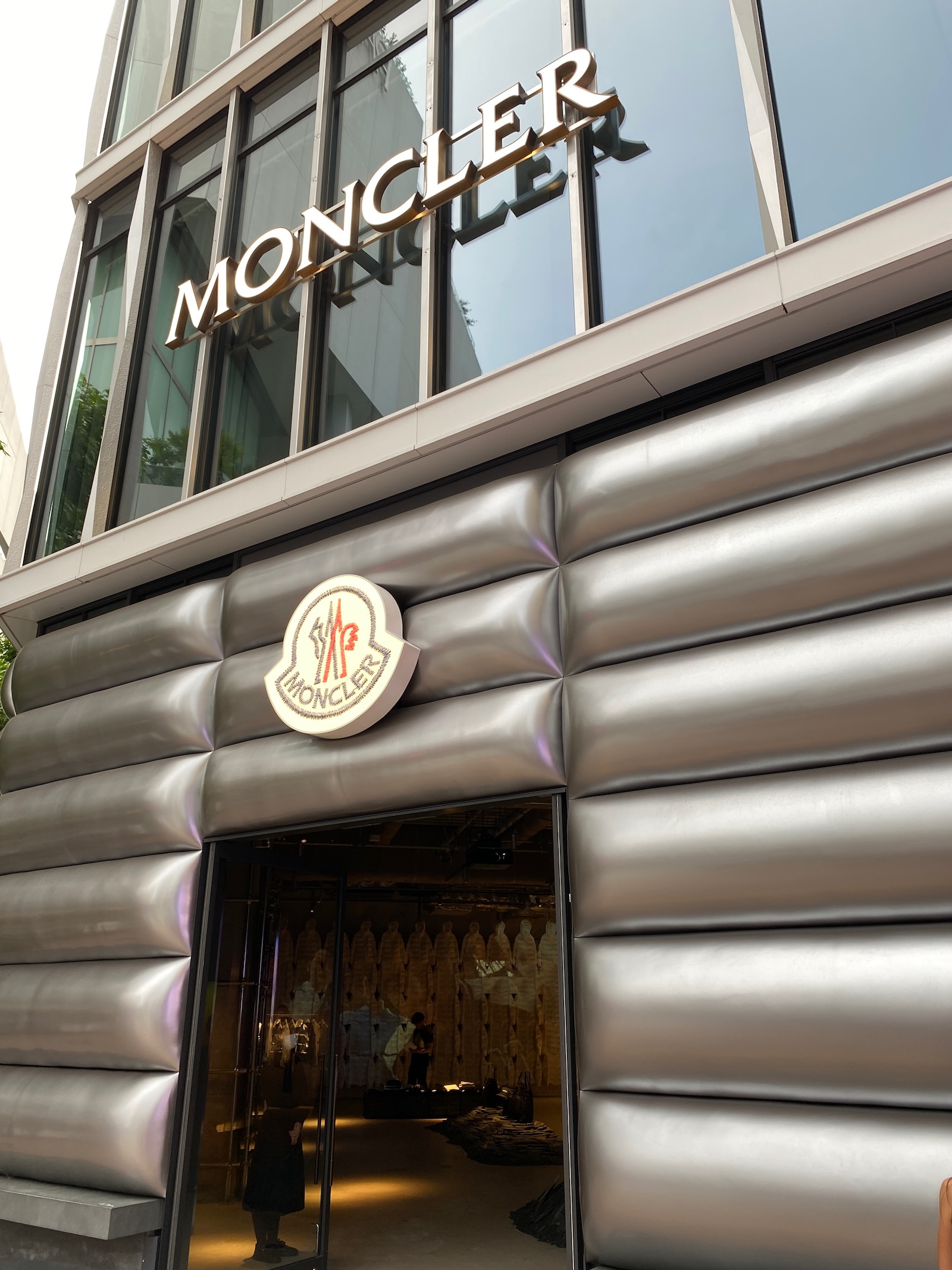 Exterior of a Moncler winter apparel store, with silver puffy sections mimicking a puffer jacket.